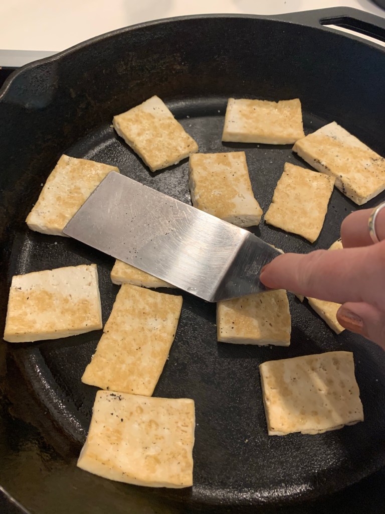 tofu sizzing in a pan