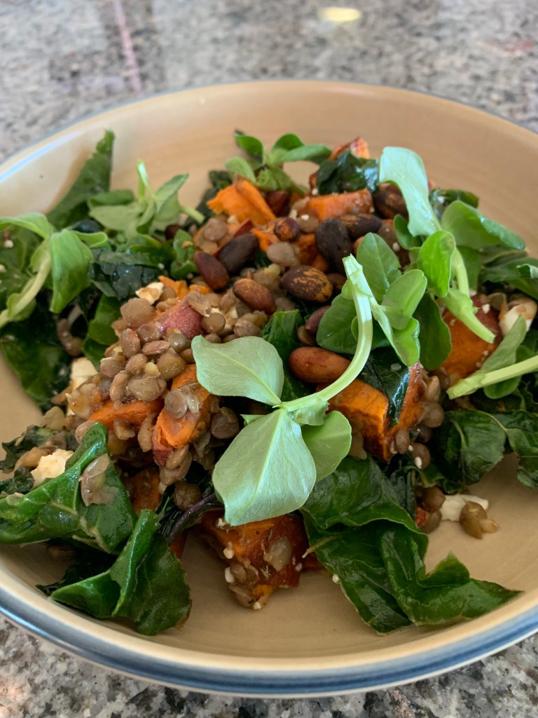 brown bowl with lentils, sweet potatoes, greens and feta cheese